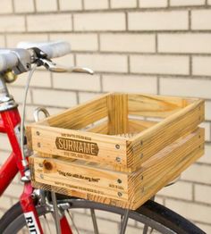 a red bicycle with a wooden crate on the front