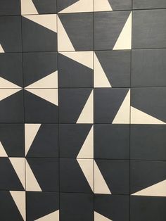 a black and white tiled wall with different shapes