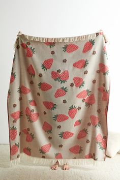 a blanket that has strawberries on it