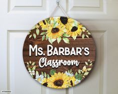 a wooden sign that says ms barbara's classroom with sunflowers