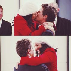 two people are hugging each other and one is wearing a santa hat