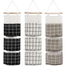 three hanging baskets with black and white grids on the sides, one has a wooden hanger