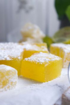 several pieces of yellow cake sitting on top of a white counter next to a spoon