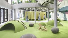 an indoor play area with green carpet and white walls