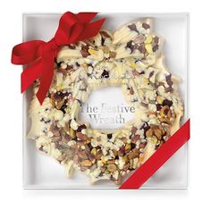 the festive wreath is decorated with nuts and red ribbon