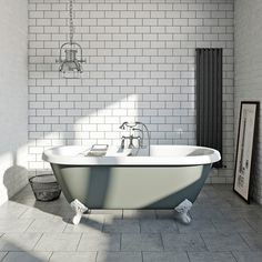 a white bath tub sitting in a bathroom next to a radiator and tiled walls