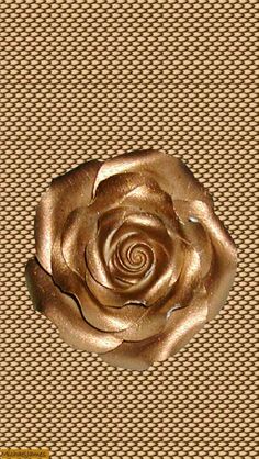 a gold rose sitting on top of a table