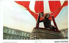 a man sitting on top of a hot air balloon