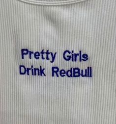 the words pretty girls drink redbull written in blue on a white t - shirt