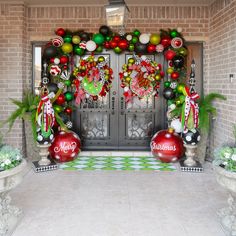 an entrance decorated for christmas with ornaments and wreaths