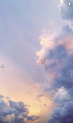 an airplane is flying in the sky with clouds