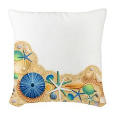 a decorative pillow with shells and starfishs on the front, along with a white background