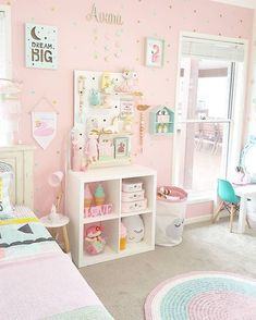 a child's bedroom decorated in pastel colors