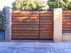 a wooden fence with two planters on each side