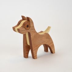 a small wooden toy dog on a white background