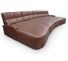 a large brown leather couch sitting on top of a white floor