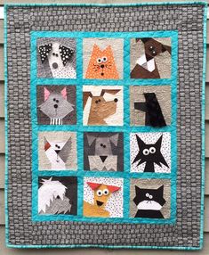 a quilt made to look like cats and dogs on a house's exterior wall