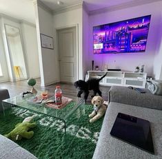 a living room filled with furniture and a dog on top of a glass coffee table