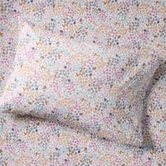 an image of a bed sheet set with flower print on the sheets and pillow cases