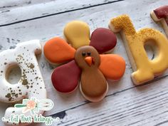 decorated cookies in the shape of letters and a turkey