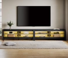 a flat screen tv mounted to the side of a wooden entertainment center in a living room