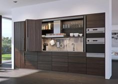 a modern kitchen with lots of cabinets and appliances