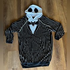 a person wearing a striped shirt with a mask on it