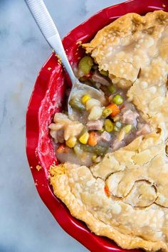 a close up of a pie on a red plate with the words, fast and easy beef pot pie