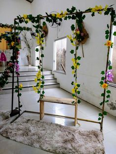 a living room with flowers on the wall and carpeted flooring, along with stairs