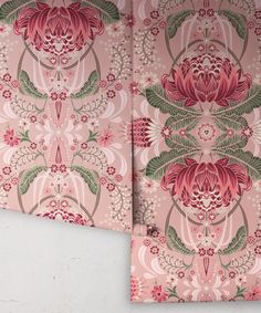 two pink and green floral wallpapers on a white wall next to each other