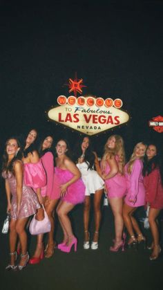 the girls are posing in front of the las vegas sign