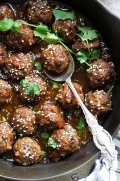 meatballs covered in sesame seeds and garnished with cilantro