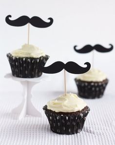 three cupcakes with fake mustache toppers on them