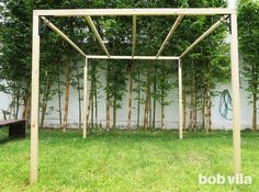 a wooden arbor in front of a white wall