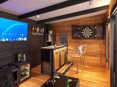 a living room with wood paneling and darts on the wall in front of it