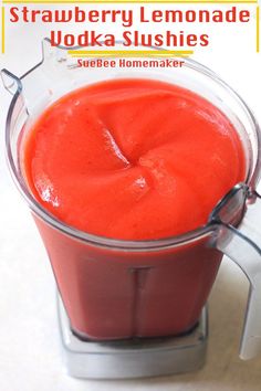 a blender filled with red liquid on top of a table