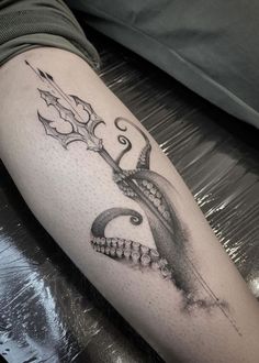 a tattoo with an octopus holding a knife