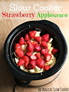 strawberries and apple slices in an electric crockpot on a wooden table top