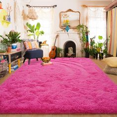 a living room filled with furniture and a pink rug