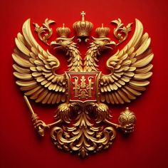 an ornate golden coat of arms and two headed eagle on a red background with gold accents