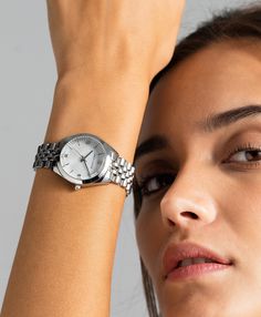 A classic design, elevated. The bold and urban Vivid watch features a statement round face with chunky outer casing that’s juxtaposed by the delicate pearlescent dial, minimalist numerals and crystal detailing. In striking silver with a 32mm face, Vivid pairs androgynous design with robust links made of stainless steel for effortless sophistication. Metallic Watches Women, Round Watches Women, Silver Watch For Women, Women Watches Classy Elegant Silver, Silver Watch Aesthetic, Silver Watches, Suits Outfits, Silver Watches Women, Watch Trends