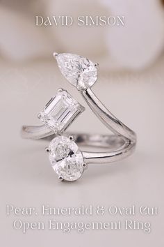 an open engagement ring with two pear shaped diamonds