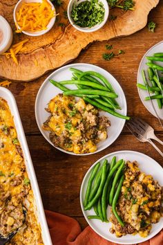 green beans and cheese casserole on plates with utensils next to it