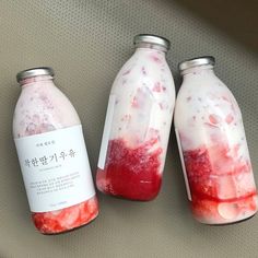 three jars filled with liquid sitting next to each other