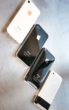 three iphones sitting next to each other on a table