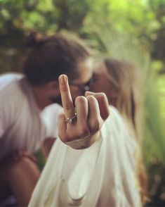 a man and woman making the v sign with their fingers as if they were kissing