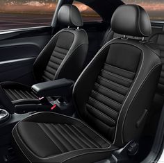 the interior of a car with black leather and stitching on it, including two front seats