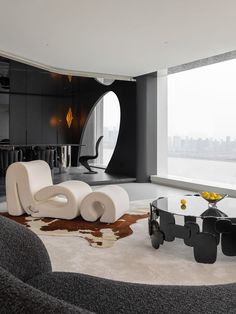 a modern living room with black and white furniture in front of a large window overlooking the city