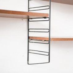 a metal shelf with two wooden shelves behind it