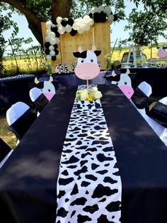 the table is decorated with black and white cow decorations